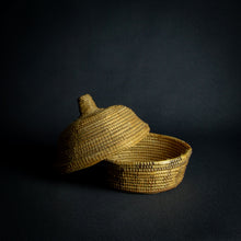 Load image into Gallery viewer, Handwoven African basket with a conical lid on a dark background.Handwoven African basket with a conical lid on a dark background.Handwoven African basket with a conical lid on a dark background.