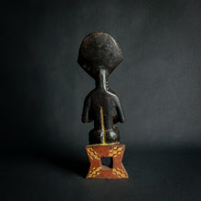 Load image into Gallery viewer, Intricately carved Ashanti Maternity figure, symbolizing fertility and traditional Ashanti motherhood, set against a dark backdrop.