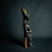 Load image into Gallery viewer, Intricately carved Ashanti Maternity figure, symbolizing fertility and traditional Ashanti motherhood, set against a dark backdrop.
