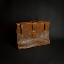Load image into Gallery viewer, Vintage brown embossed leather briefcase with gold-tone hardware on a dark background.