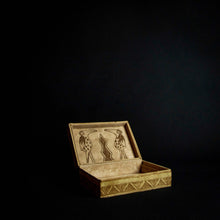 Load image into Gallery viewer, A close-up image of a beautiful box made of animal skin with intricate designs inspired by Senufo masks and animals. The box is adorned with rich patterns and textures, and has a unique and rustic feel. It can be used for storage or as a decorative piece in any home.