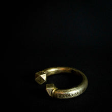 Load image into Gallery viewer, A close-up photo of a vintage brass bracelet with ethnic designs, showcasing the intricate patterns and rustic feel of the brass material.