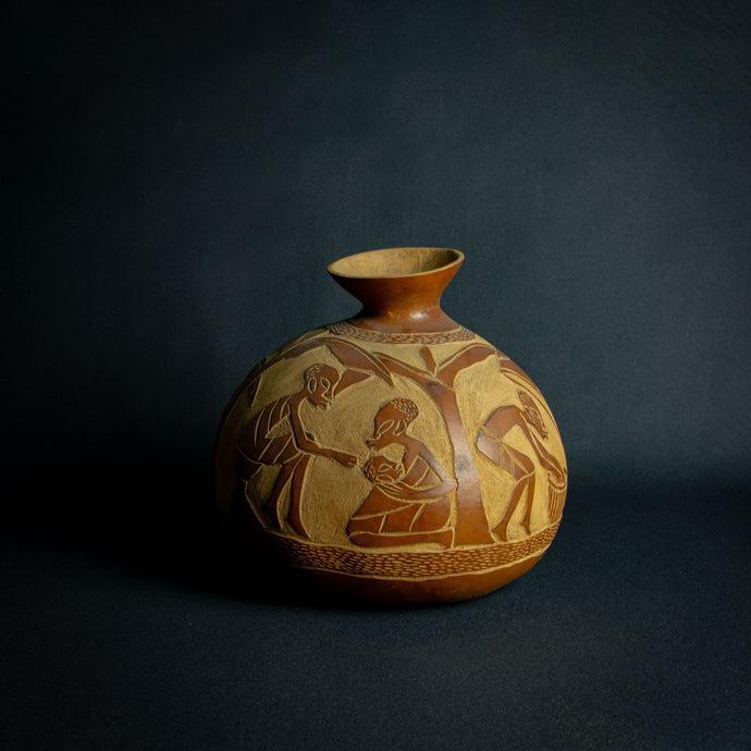 Artisanal calabash vase engraved with scenes of African daily life, highlighting the rich cultural tapestry and community spirit.