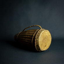 Load image into Gallery viewer, Traditional African hand drum with a tapered wooden body, intricate ropework, and a weathered hide head, evoking the spirit of African music.
