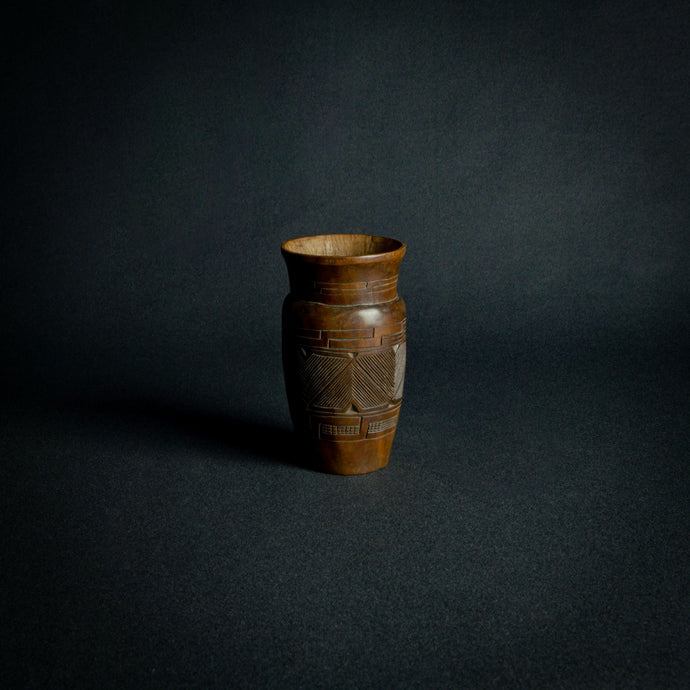 Kuba wooden cup with traditional patterns, symbolizing cultural status and craftsmanship.