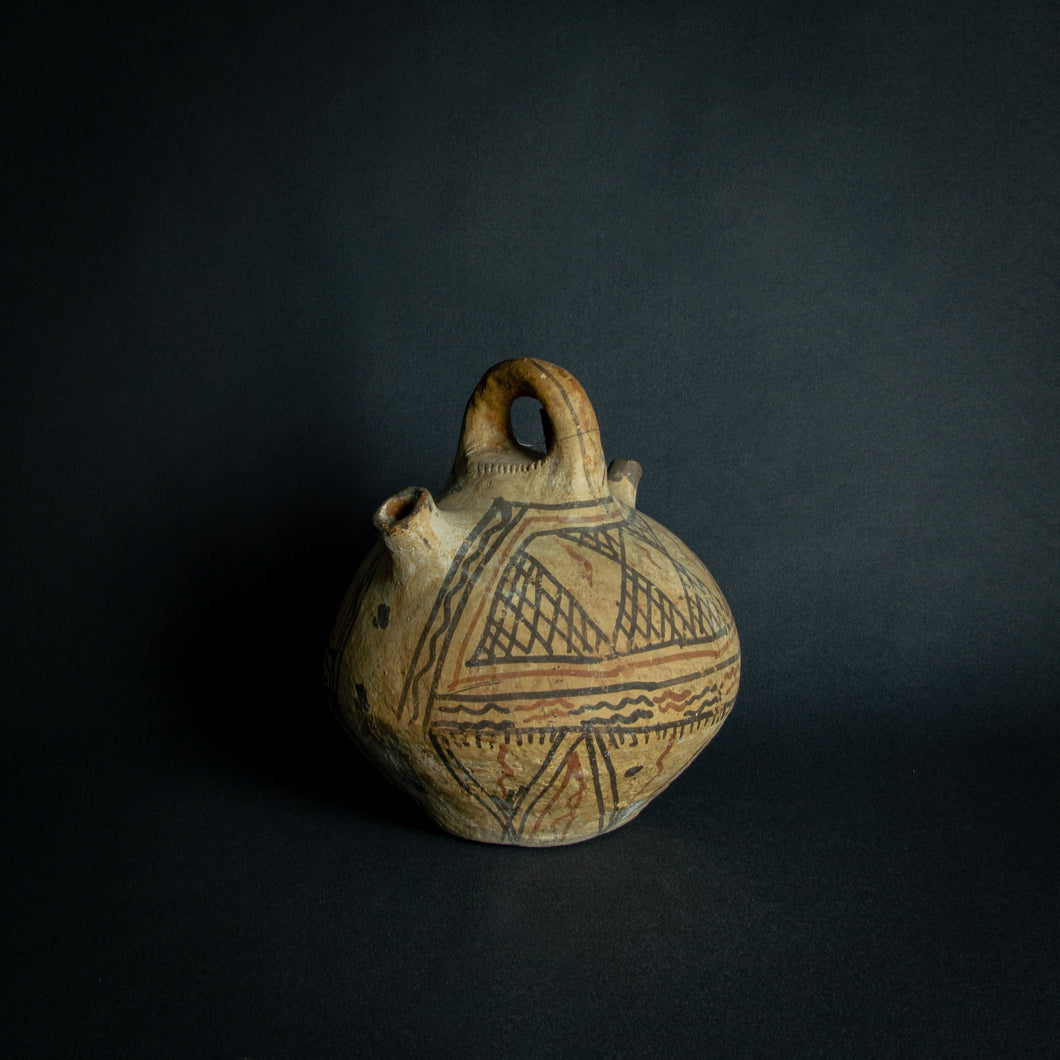 Handcrafted African earthenware vessel with traditional geometric patterns, symbolizing the artistry and heritage of African pottery.