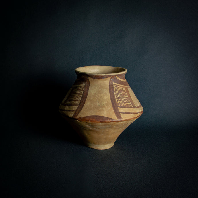 African clay vessel with hand-painted geometric patterns, embodying traditional tribal artistry.