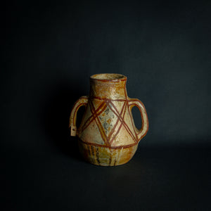 African clay pot with traditional painted geometric patterns, a testament to timeless craftsmanship.