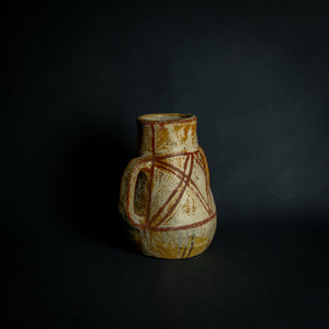 African clay pot with traditional painted geometric patterns, a testament to timeless craftsmanship.