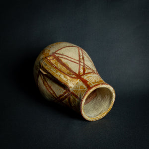 African clay pot with traditional painted geometric patterns, a testament to timeless craftsmanship.