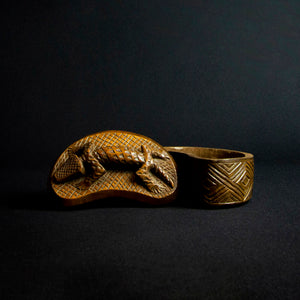 Handcrafted wooden box with half-moon shape and intricately carved crocodile on lid, made by Kuba tribe artisans in the D.R. Congo. Perfect for storage or as a decorative accent in any room.