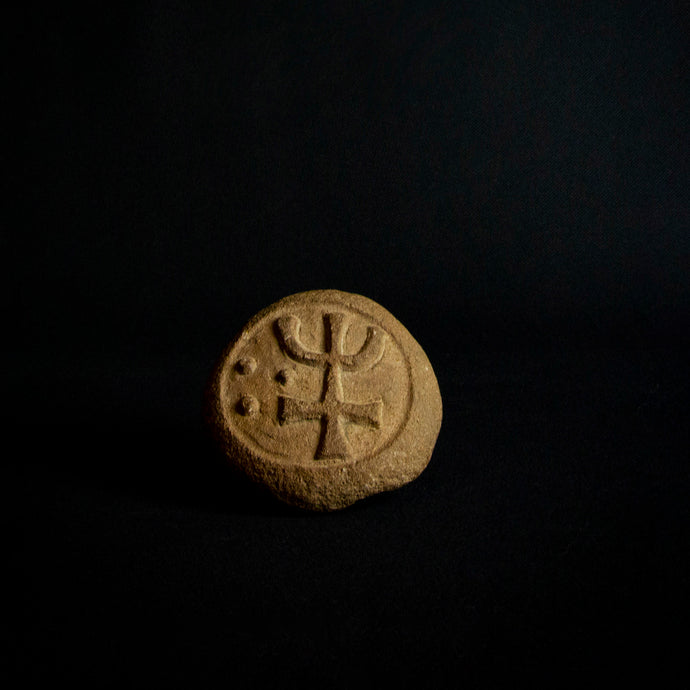 Engraved stone with intricate symbols.