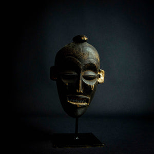 Chokwe Pwo Mask from Angola, Africa representing a beautiful woman with scarifications on her face, which symbolize beauty and status in the community.