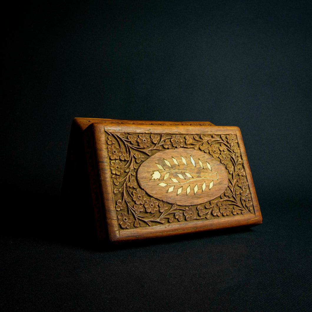 Handcrafted Indian rosewood box with intricate flower carvings on the lid, perfect for storage or decoration.