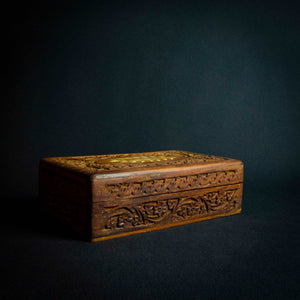 Handcrafted Indian rosewood box with intricate flower carvings on the lid, perfect for storage or decoration.