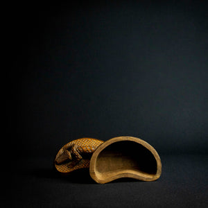 Handcrafted wooden box with half-moon shape and intricately carved crocodile on lid, made by Kuba tribe artisans in the D.R. Congo. Perfect for storage or as a decorative accent in any room.