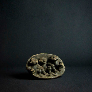 Terracotta sculpture of three figures from the Bamum tribe in Cameroon, featuring intricate details and unique characteristics.